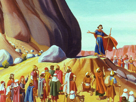 Mojżesz posłuchał i zebrał wszystkich przed wielką skałą poza obozem. Potem uderzył w skałę swoją laską. – Slajd 9